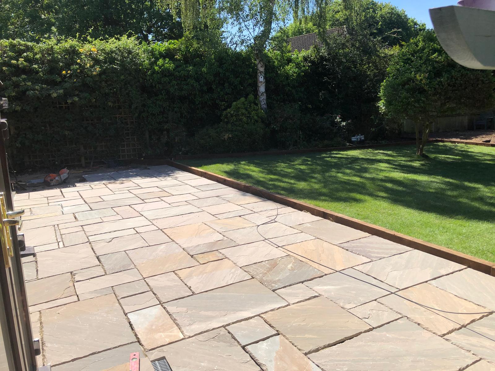 Sandstone patio with lawn