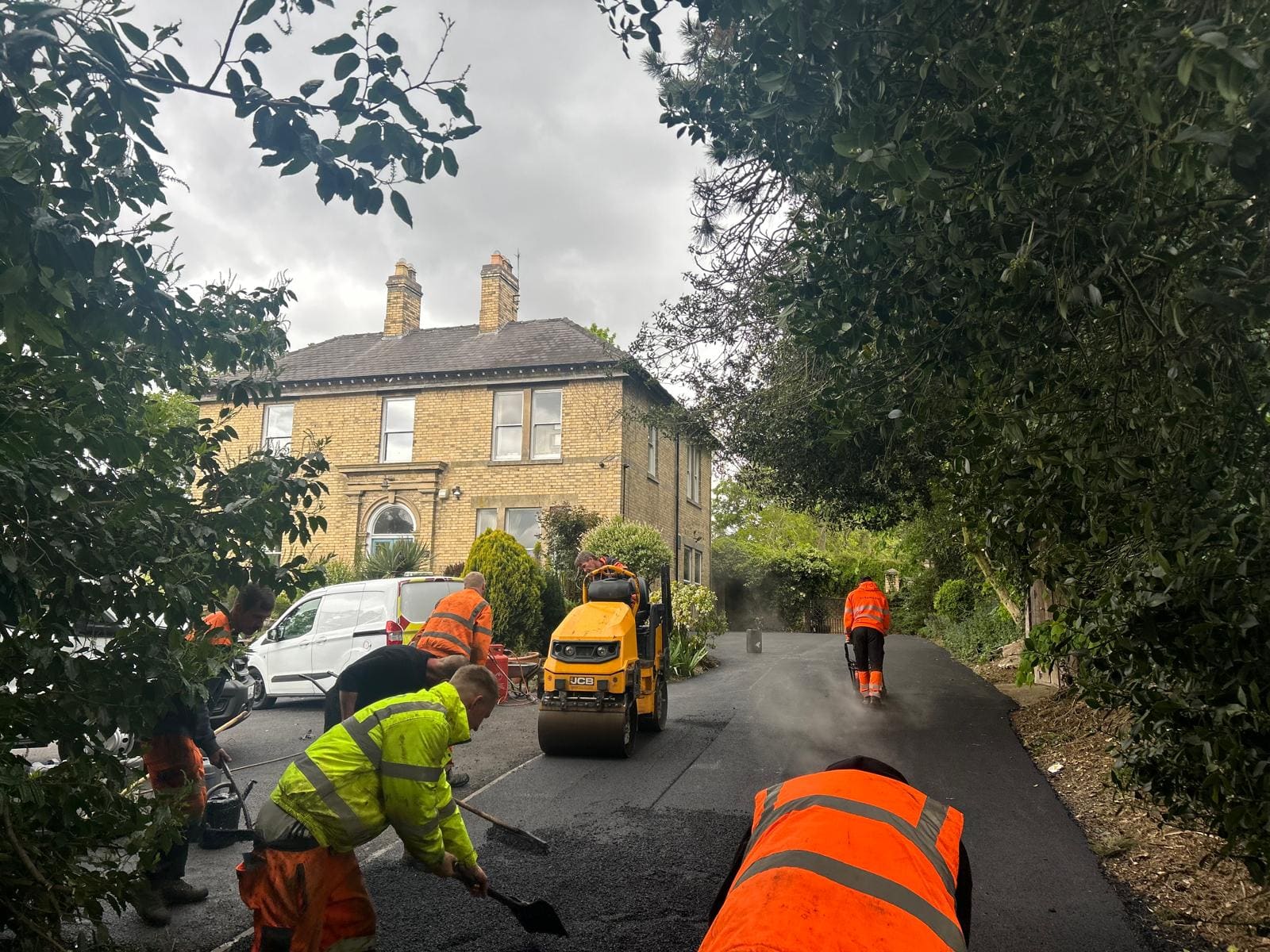 Crew laying tarmac