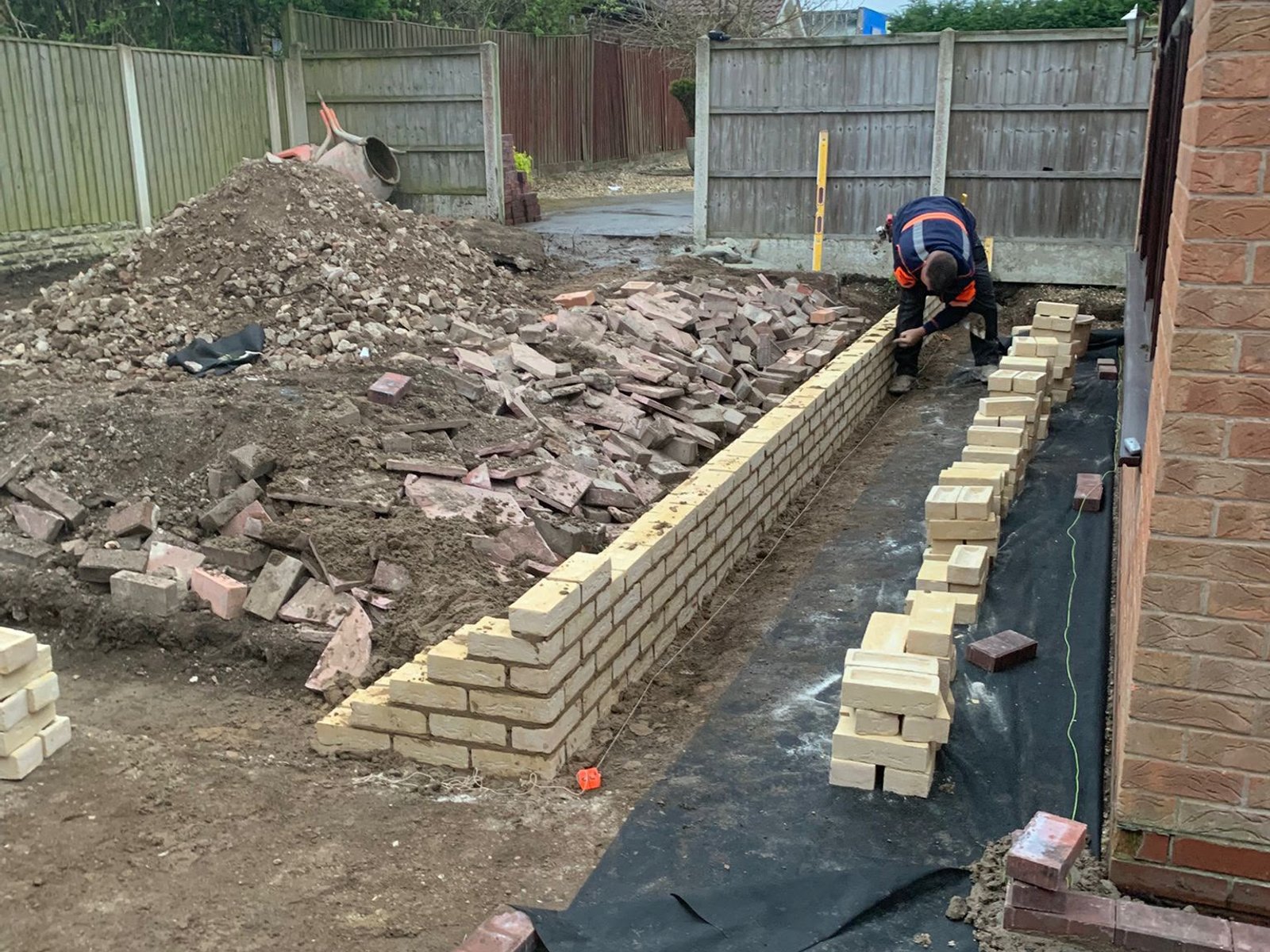 LB Construction team member building a garden brick wall